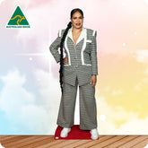 Woman in a houndstooth patterned suit standing on a wooden floor with a colorful background, featuring the 'Australian Made' logo.